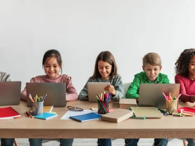 children using laptop in school