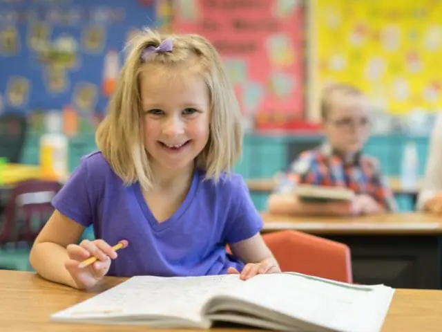 1st grader smiling in class