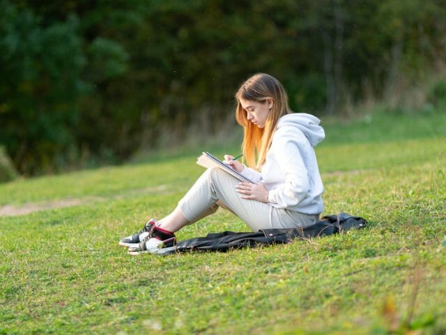 8th grader writing outdoor