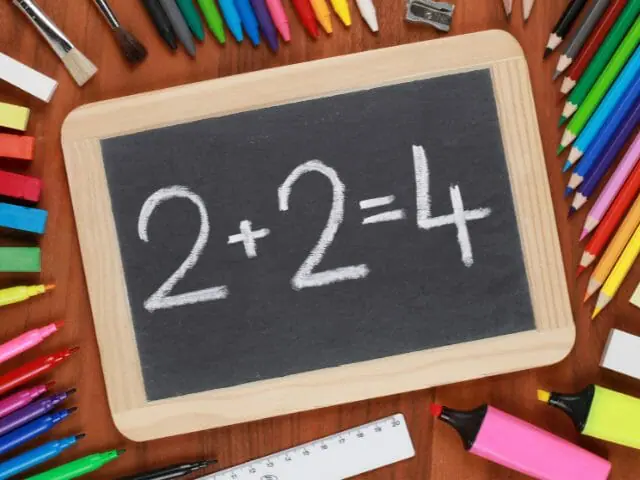 addition equation on rectangle shape board with colored pencils