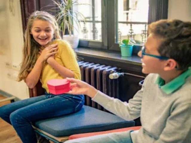 boy giving gift to a girl classmate