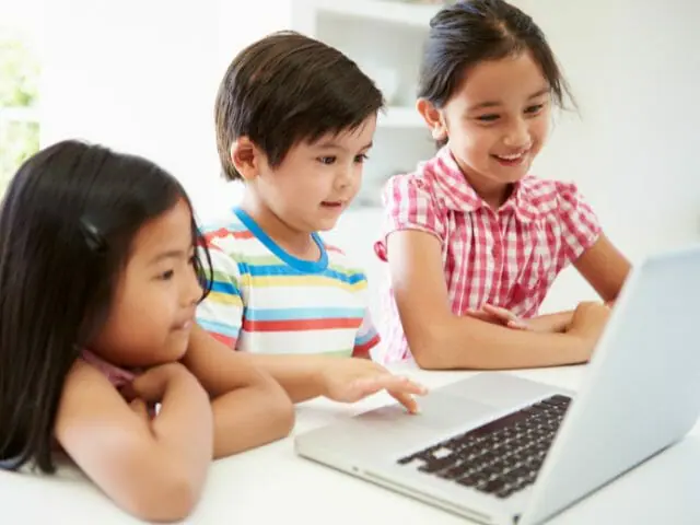 children using laptop reading stories