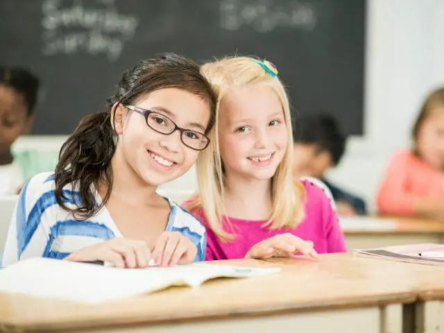 elementary students smiling in class