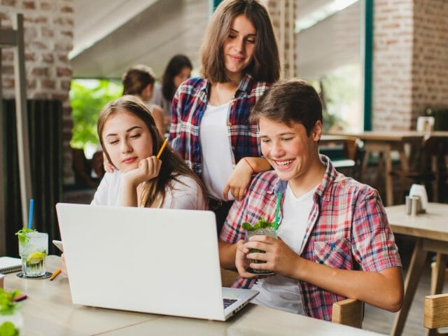 group of students using laptop