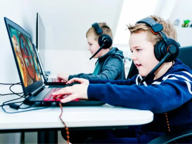 kids playing video games using laptop