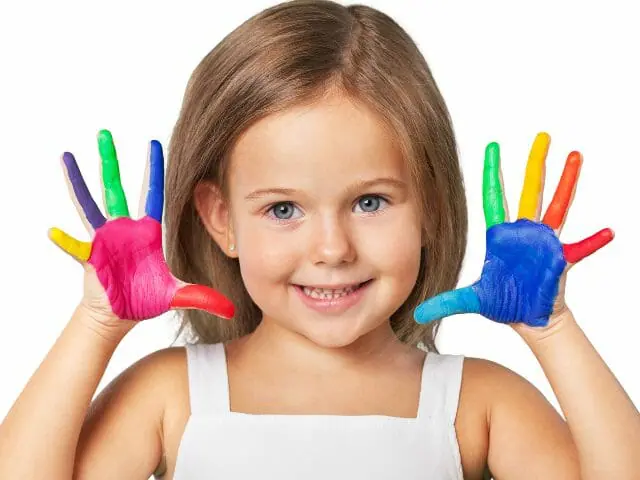 little girl smiling with messy finger