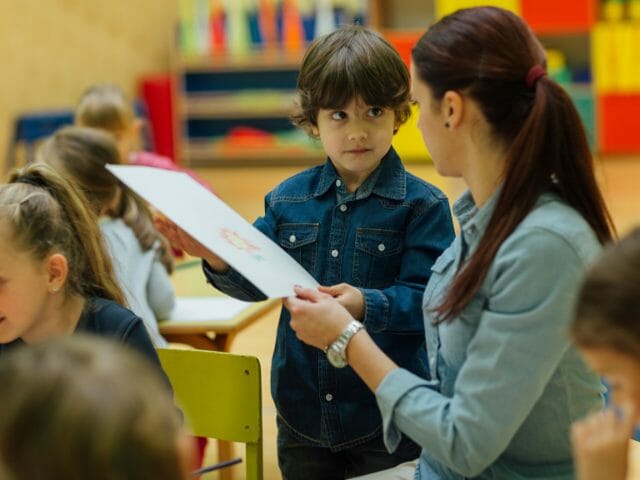 preschool teacher and children in classroom