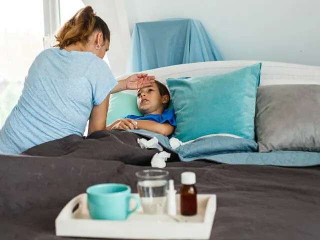 sick kid with mother at home