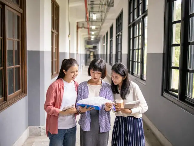 students in school corridor discussion