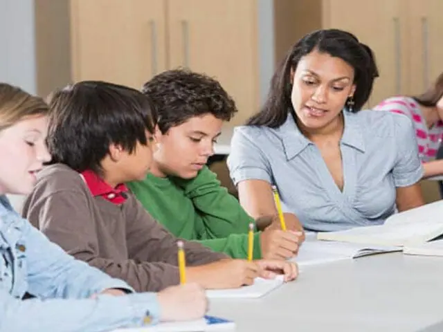 teacher helping students in class